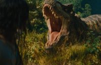 A Tyrannosaurus rex roaring with its mouth wide open in the middle of the jungle