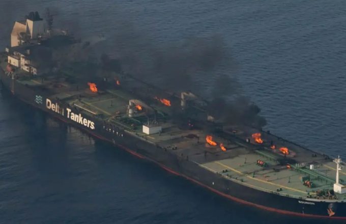 A ship in flames in the middle of the sea